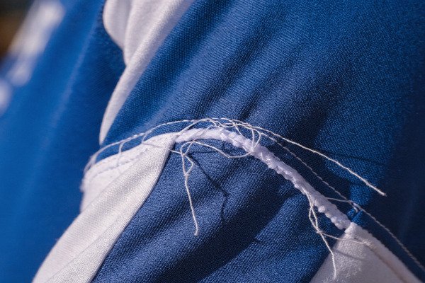 A close-up of a poorly stitched seam on a soccer jersey